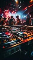 AI generated DJ's hands on a mixing board, with a blurred background of energetic partygoers dancing in the club photo