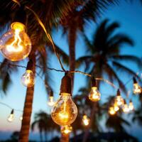 AI generated string of light bulb garlands hanging between two palm trees on a beach photo