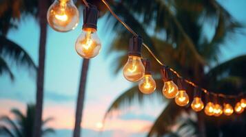 AI generated string of light bulb garlands hanging between two palm trees on a beach photo