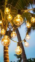 AI generated string of light bulb garlands hanging between two palm trees on a beach photo