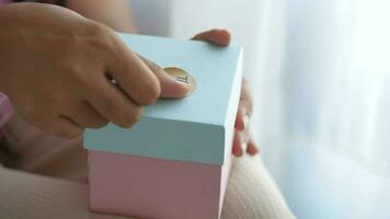 women hand putting a thank you sticker on a gift box video