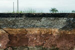 The layer of asphalt road with soil and rock. photo