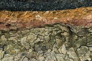 The layer of asphalt road with soil and rock. photo