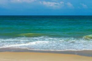 Green water in the sea on the beach. photo