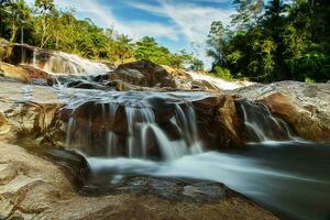 Small waterfall and stone with water motion. photo