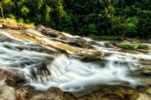 Small waterfall and stone with water motion. photo