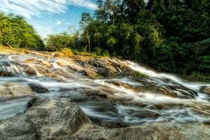 Small waterfall and stone with water motion. photo