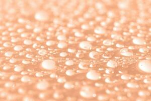 Lots of drops on a Peach Fuzz background. photo