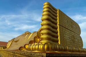 Close up of the golden Buddha statue. photo