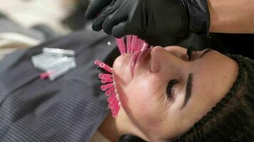 A young woman undergoes a face lift procedure. Facial skin care, anti-aging face contour correction. The beautician implants cosmetic threads under the skin to relieve facial ptosis. video