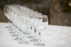 Row of glasses diagonally. Wine glasses for a buffet table photo