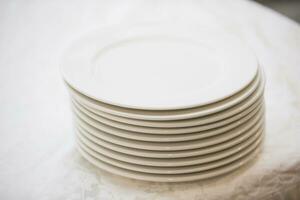 A stack of white plates on the table photo