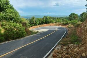 Empty curved road to the mountain. photo