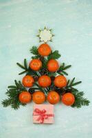 Blue winter background with pattern of christmas decorations, tangerines, cones, gingerbread photo