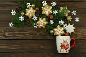 Dark brown wooden winter background with christmas decorations, gingerbread and copy space photo