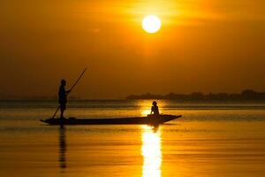 Fishermen and fishing boats float in the lake. photo