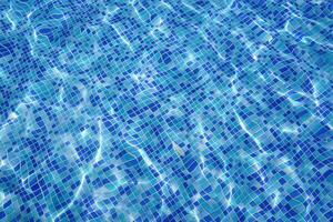 defocus blurred blue water in pool rippled water background. Swimming pool texture, water wave under texture background. photo