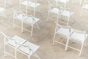rows of folding chairs, empty seats on event - chair row photo