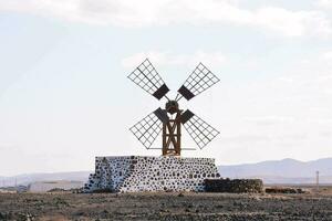 a windmill in the middle of a desert photo