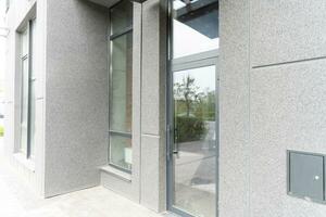 Abstract fragment of modern architecture, gray walls, glass and concrete. photo