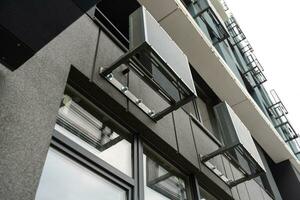 Abstract fragment of modern architecture, gray walls, glass and concrete. photo