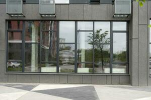Abstract fragment of modern architecture, gray walls, glass and concrete. photo