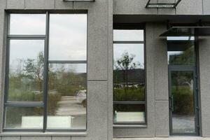 Abstract fragment of modern architecture, gray walls, glass and concrete. photo