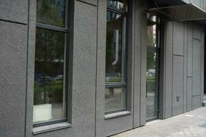 Abstract fragment of modern architecture, gray walls, glass and concrete. photo