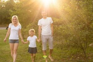 happy young family spending time outdoor on a summer day photo