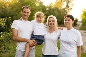 Happy family enjoying in park on sunny a day photo