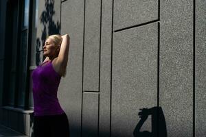 Sport woman doing stretching exercise during outdoor cross training workout photo