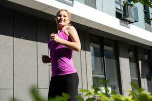 Sport woman doing stretching exercise during outdoor cross training workout photo