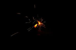 A lit sparkler showing bright sparks photo