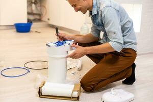 Installation of reverse osmosis water purification system. photo