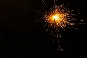 A lit sparkler showing bright sparks photo