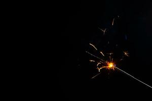 A lit sparkler showing bright sparks photo