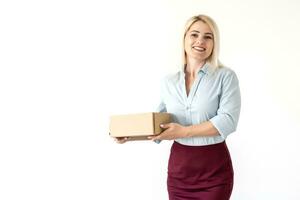 A young beautiful caucasian woman holding a box in her hands. photo