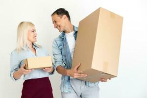 moving, home and family concept - smiling couple holding cardboard boxes photo