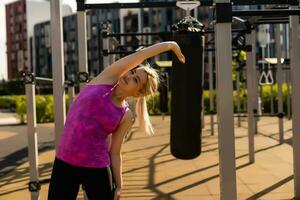 fitness woman doing situps in outdoor gym woking out strength training photo