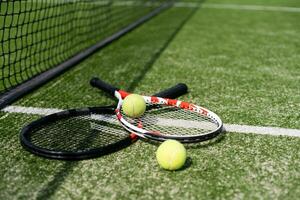 A tennis racket and new tennis ball on a freshly painted tennis court photo