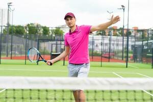 Male tennis player on the tennis court photo