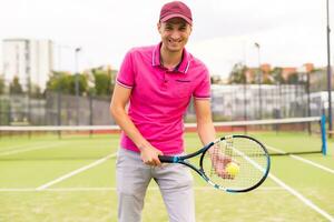 Male tennis player on the tennis court photo