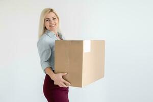 A young beautiful caucasian woman holding a box in her hands. photo