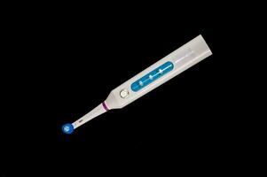 an electric toothbrush on a black background photo