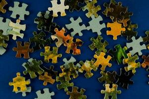 a pile of puzzle pieces on a blue background photo