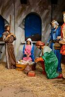 a nativity scene with figurines of people and animals photo