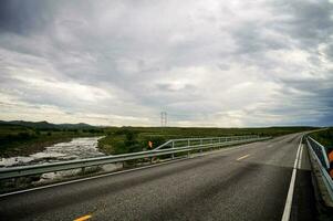 un puente terminado un río con un nublado cielo foto