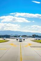 AI generated panoramic view of an airport runway with planes parked and in motion photo