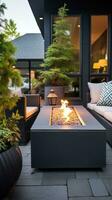 ai generado hermosamente diseñado al aire libre patio zona con moderno muebles, en conserva plantas, y un acogedor fuego fosa. foto