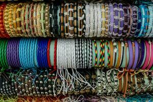 many different types of bracelets are displayed in a row photo